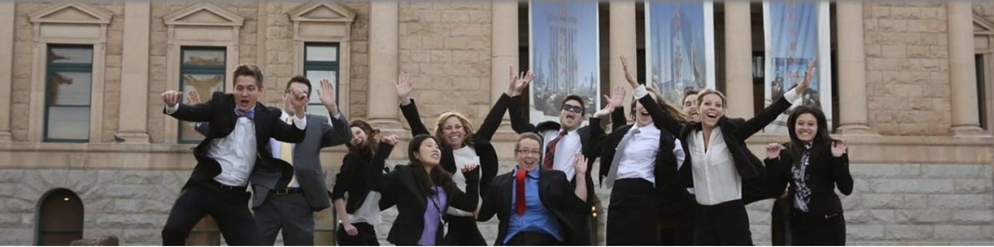 Interns jumping in front of A Z state capital.